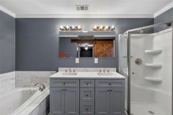 a bathroom with a sink double vanity and a shower