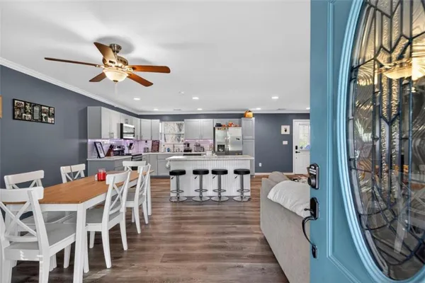 a view of a dining room with furniture and a chandelier