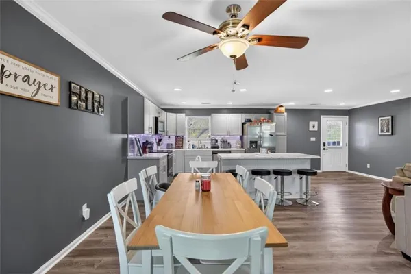 a dining room with furniture and wooden floor