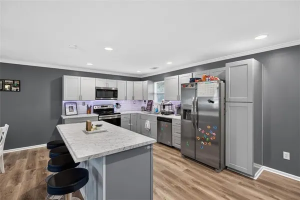 a kitchen with stainless steel appliances a refrigerator and a stove top oven