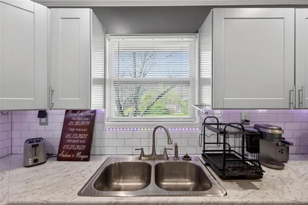 a bathroom with a sink and a window