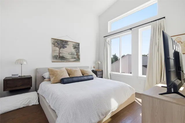 a bedroom with a bed and a flat screen tv