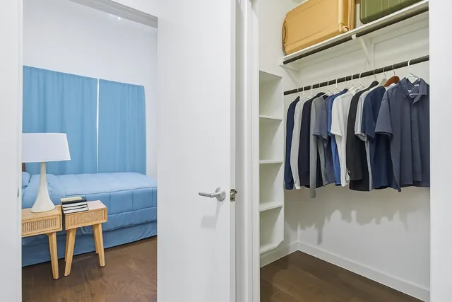 a white house that has a tree on the side of it