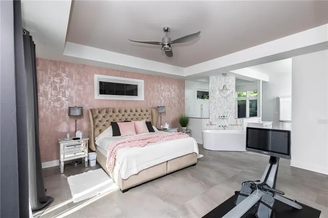 a spacious bedroom with a bed and a desk