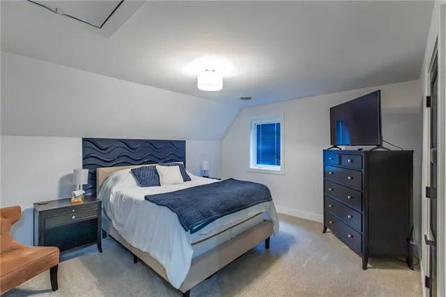 a bedroom with a bed and a night stand