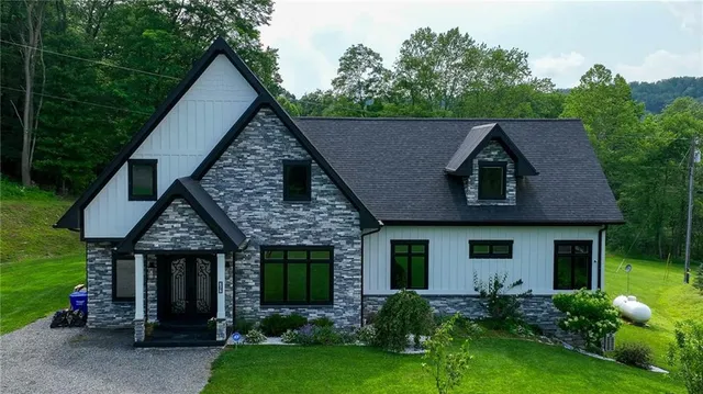 a front view of a house with garden