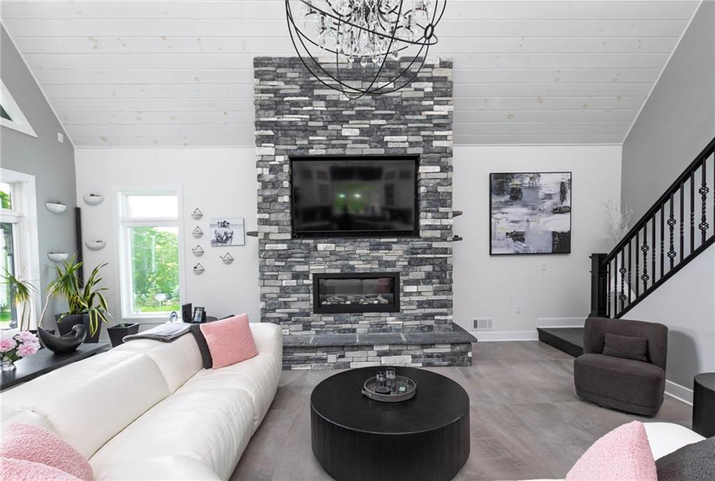 267 Reibold Road Renfrew, PA 16053 - Photo 9 of 39 a living room with furniture a fireplace and a flat screen tv