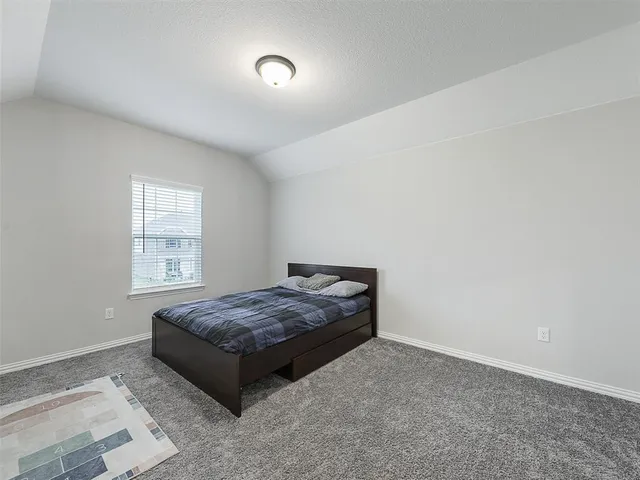 a living room with a bed and a window