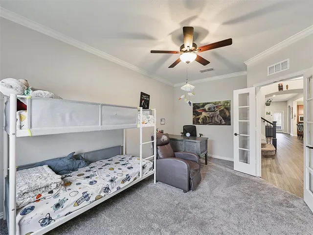 a bedroom with a bed and a chandelier