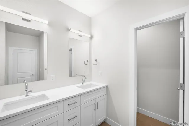 a bathroom with a double vanity sink mirror and next