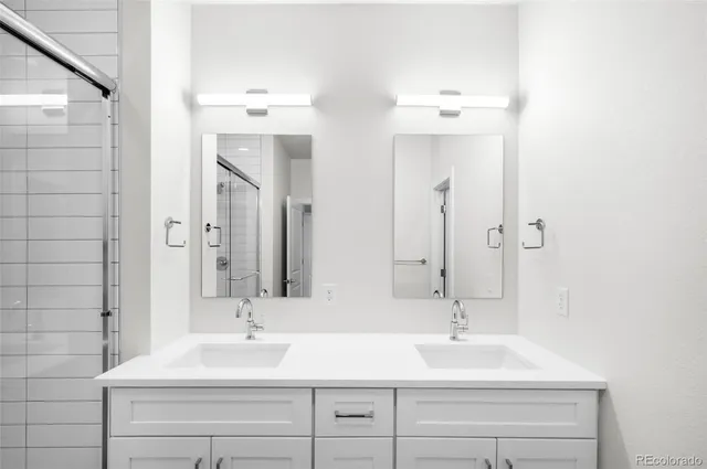 a bathroom with a sink double vanity and a mirror