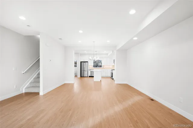 a view of kitchen and hall with wooden floor