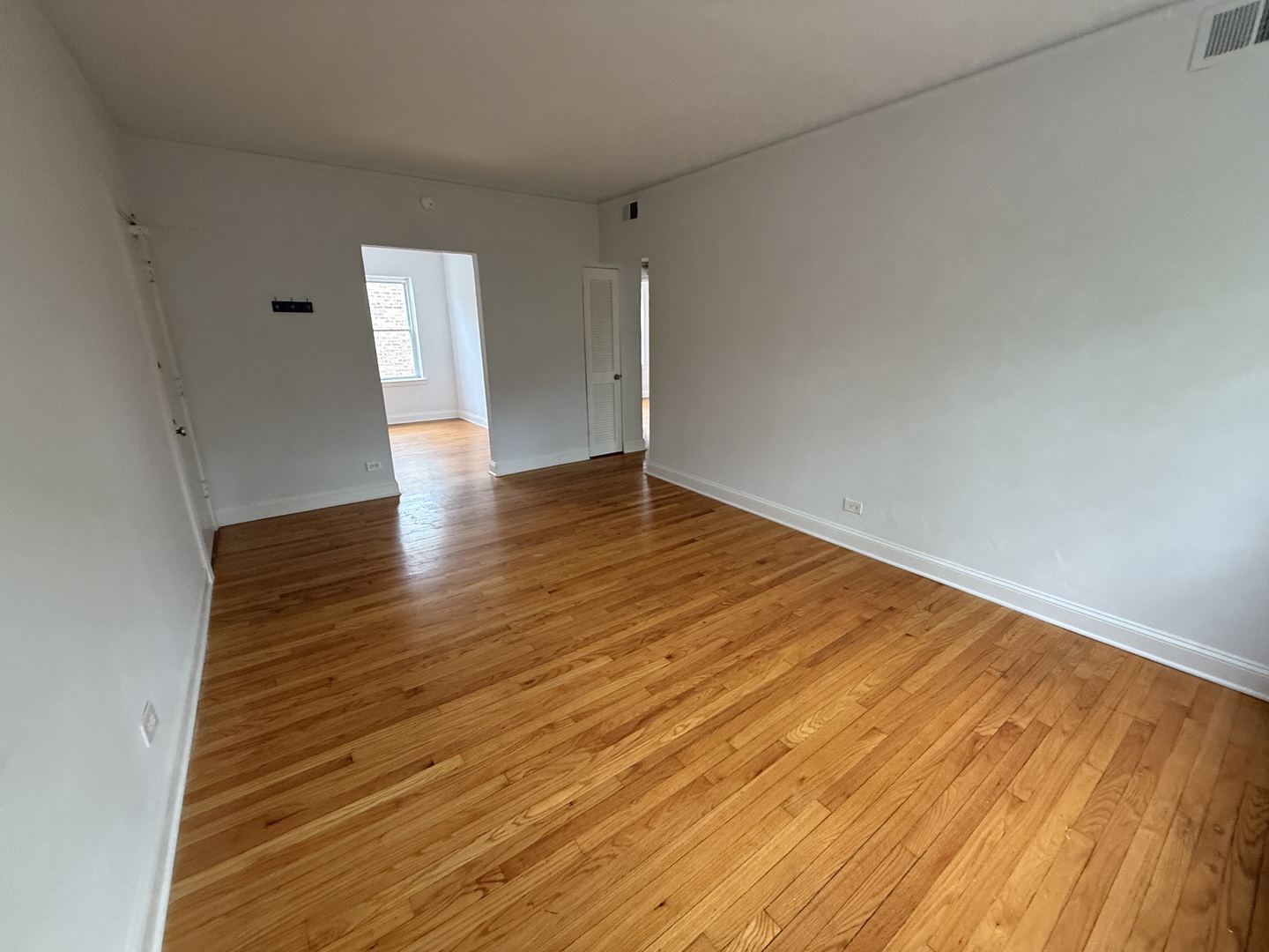 2004 West Jarvis Avenue, Unit 3 Chicago, IL 60645 - Photo 3 of 12 wooden floor in an empty room