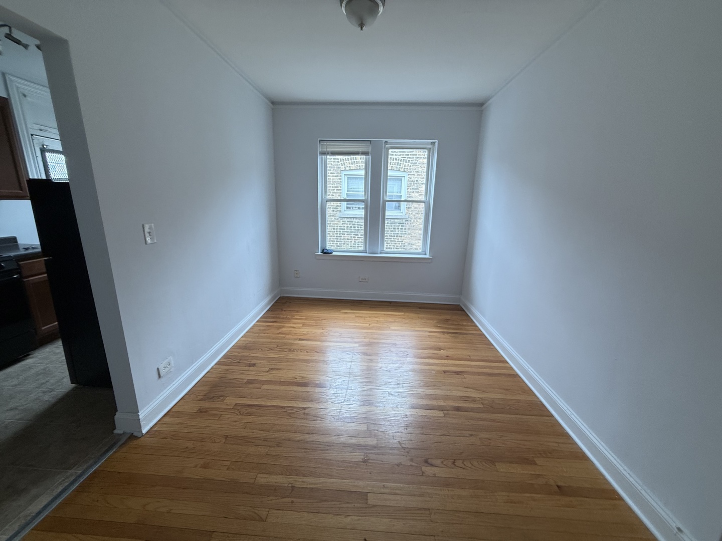 2004 West Jarvis Avenue, Unit 3 Chicago, IL 60645 - Photo 4 of 12 a view of empty room with wooden floor and fan