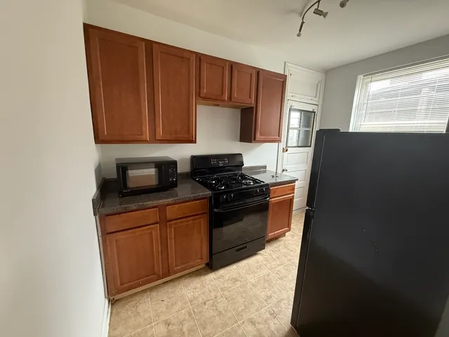 a kitchen with a refrigerator stove and sink