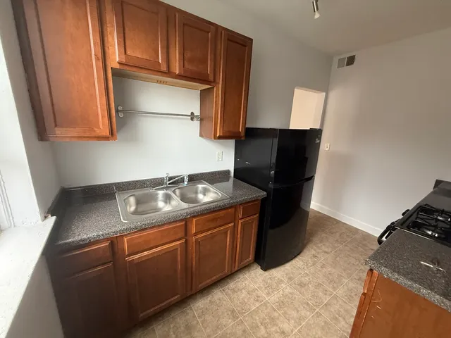 a kitchen with stainless steel appliances granite countertop a stove and a refrigerator