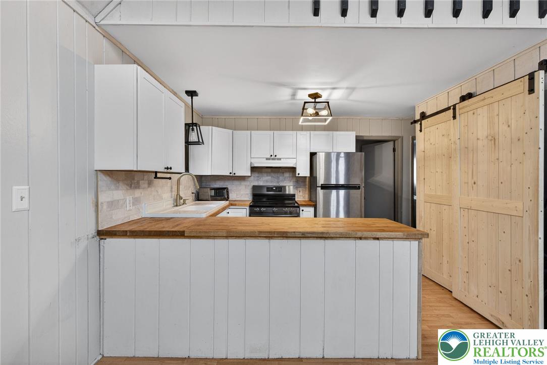 149 Regent Street Bushkill, PA 18324 - Photo 15 of 32 a view of kitchen with stainless steel appliances granite countertop refrigerator sink and stove