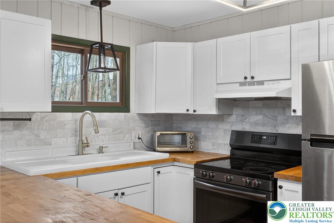 149 Regent Street Bushkill, PA 18324 - Photo 16 of 32 a kitchen with stainless steel appliances a stove a sink and cabinets
