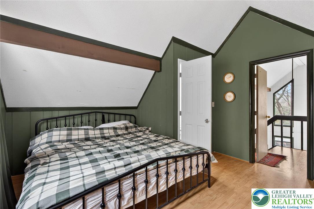 149 Regent Street Bushkill, PA 18324 - Photo 27 of 32 a bedroom with a bed and wooden floor