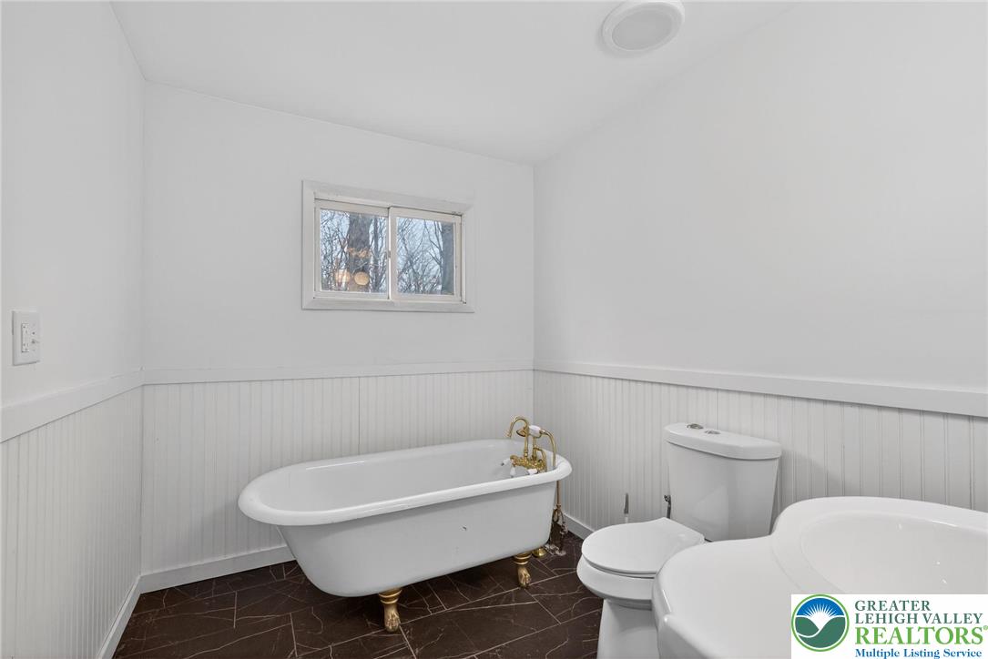 149 Regent Street Bushkill, PA 18324 - Photo 28 of 32 a white toilet sitting next to a bathroom sink