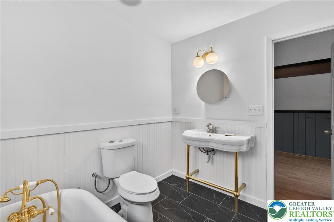 149 Regent Street Bushkill, PA 18324 - Photo 29 of 32 a bathroom with a sink toilet and mirror