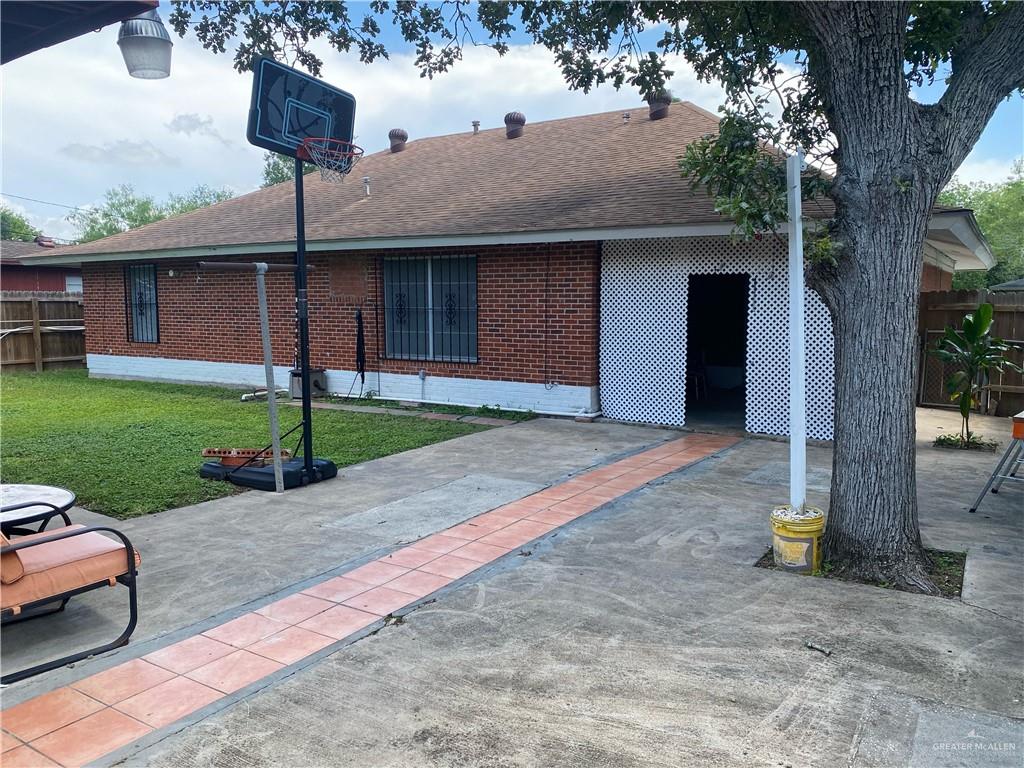 616 5th Street Weslaco, TX 78596 - Photo 5 of 6 a front view of a house with a yard and garage