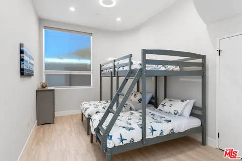 a bed sitting in a room next to a lamp