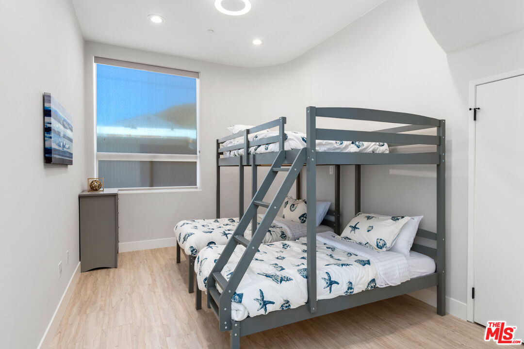 43250 Pacific Coast Highway Malibu, CA 90265 - Photo 18 of 21 a bed sitting in a room next to a lamp