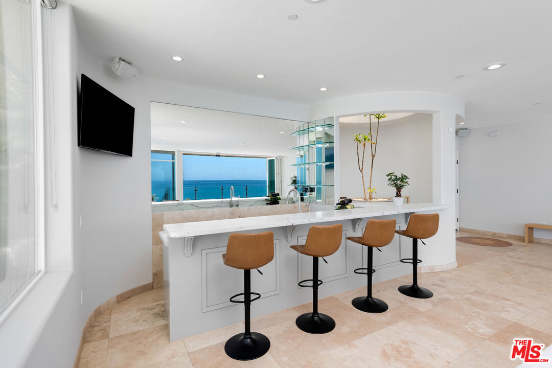 43250 Pacific Coast Highway Malibu, CA 90265 - Photo 8 of 21 a view of kitchen island with stainless steel appliances kitchen island sink refrigerator and dining table