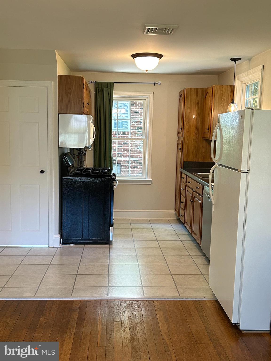 51 Homeland Road York, PA 17403 - Photo 9 of 45 a kitchen with a refrigerator and a stove