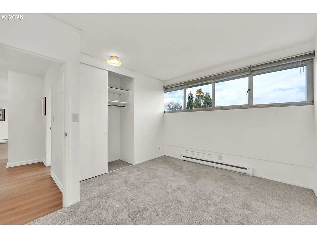1313 Lincoln Street, Unit 508 Eugene, OR 97401 - Photo 11 of 22 an empty room with wooden floor and windows