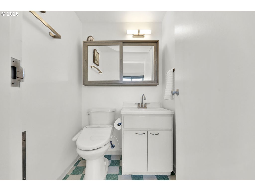 1313 Lincoln Street, Unit 508 Eugene, OR 97401 - Photo 13 of 22 a bathroom with a toilet sink and mirror