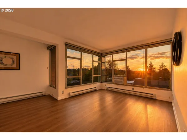 a view of room with window and wooden floor