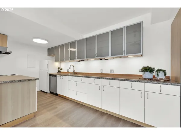 a kitchen with granite countertop a sink and a stove