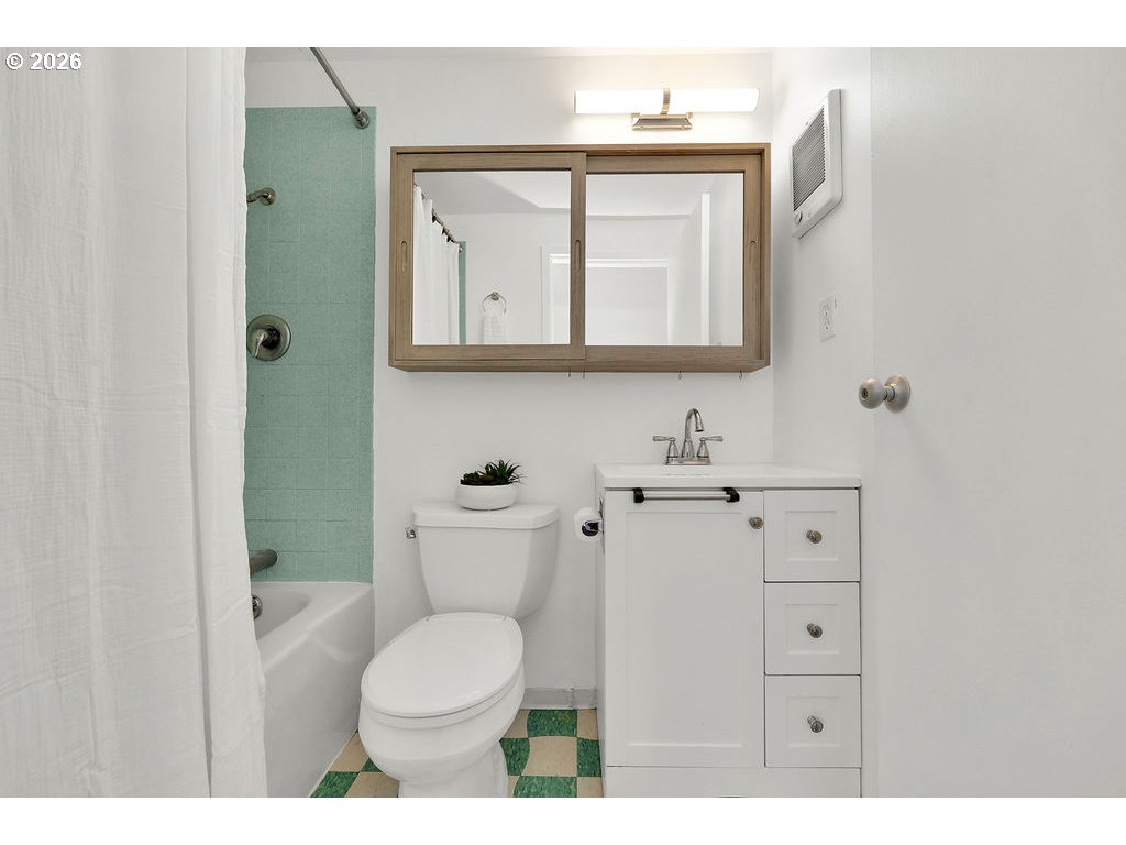 1313 Lincoln Street, Unit 508 Eugene, OR 97401 - Photo 9 of 22 a bathroom with a toilet sink vanity and mirror