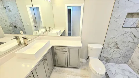 a bathroom with a toilet and shower