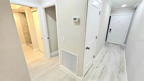 a view of empty room with wooden floor and floor to ceiling window