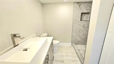 a view of a lake with a table and chairs