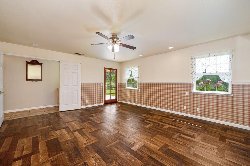 6181 Lambert Lane El Dorado, CA 95623 - Photo 45 of 68 empty room featuring a wainscoted wall, recessed lighting, a ceiling fan, parquet floors, and wallpapered walls