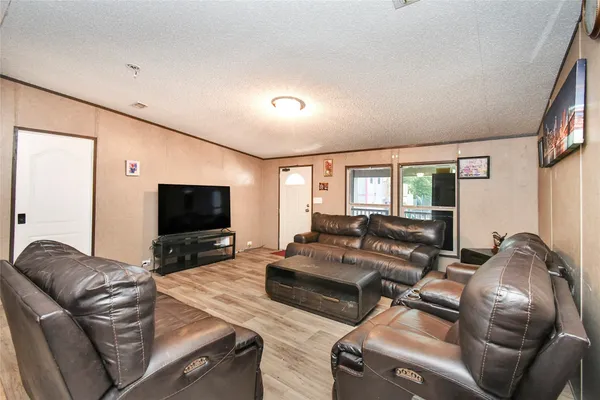 a kitchen with stainless steel appliances kitchen island granite countertop a refrigerator stove and sink