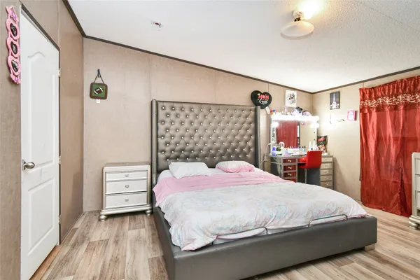 a bedroom with baby bed and dresser