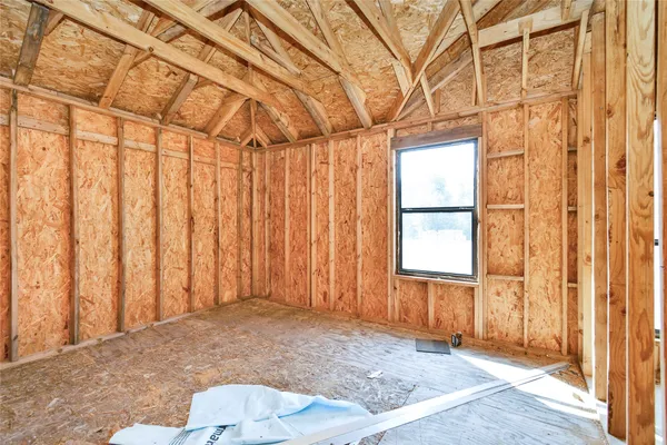 a bathroom with a granite countertop double vanity sink a mirror and a shower