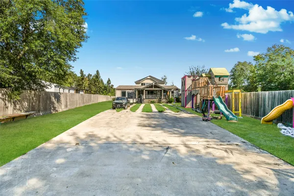 a view of a house with backyard and a slide