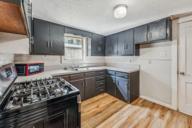 a kitchen with stainless steel appliances granite countertop a stove and a sink