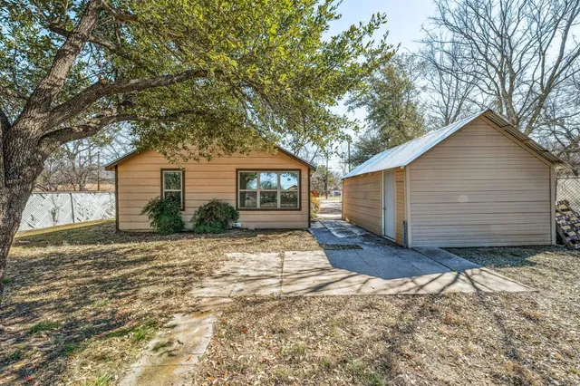 a view of yard covered with snow in front of house