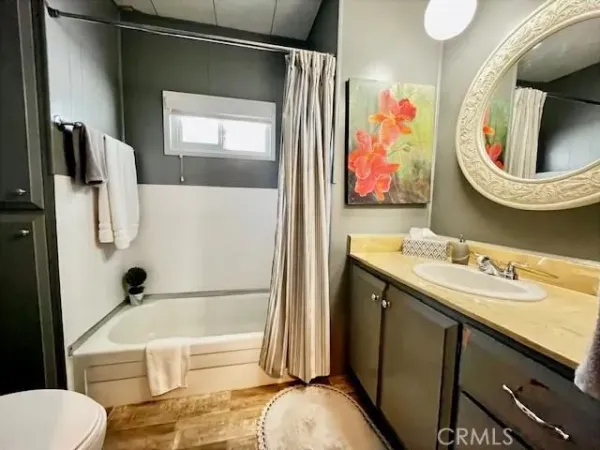 a bathroom with a sink a toilet and bathtub