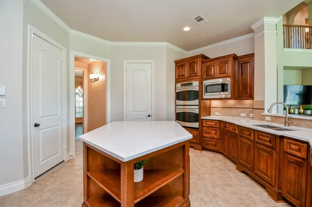 a kitchen that has a lot of cabinets in it