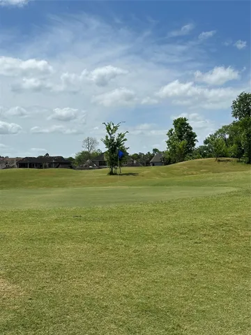 a view of an chairs and deck in the backyard