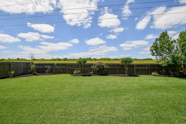 a view of a hallway with entryway wooden floor and front door