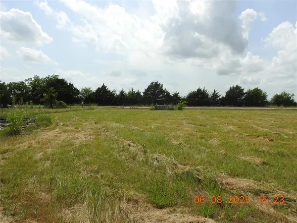 a view of a field with an ocean